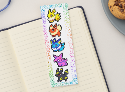 Bookmark with cartoon characters on a notebook next to cookies and glasses